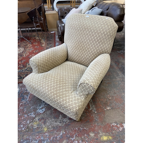 30 - A Victorian style beige fabric upholstered armchair on beech supports and brass castors - approx. 87... 