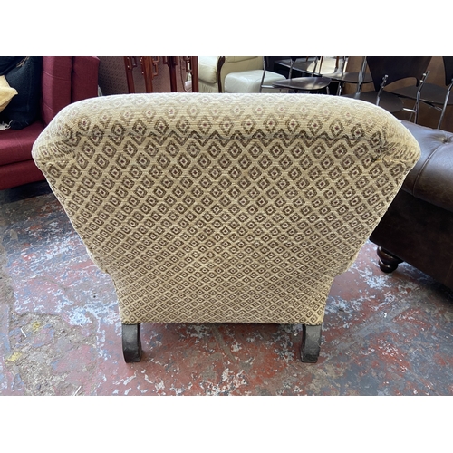 30 - A Victorian style beige fabric upholstered armchair on beech supports and brass castors - approx. 87... 