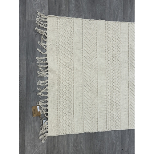 38 - Five Walton & Co 100% recycled PET yarn items, one throw - approx. 127cm x 152cm and four rugs, thre... 