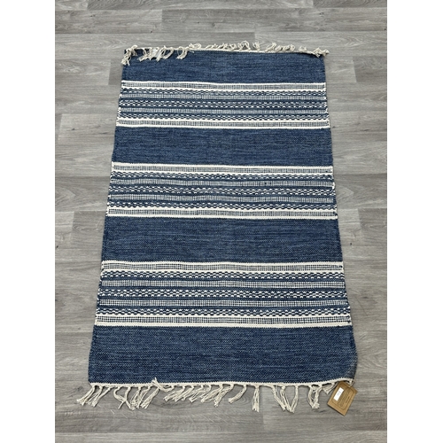 38 - Five Walton & Co 100% recycled PET yarn items, one throw - approx. 127cm x 152cm and four rugs, thre... 