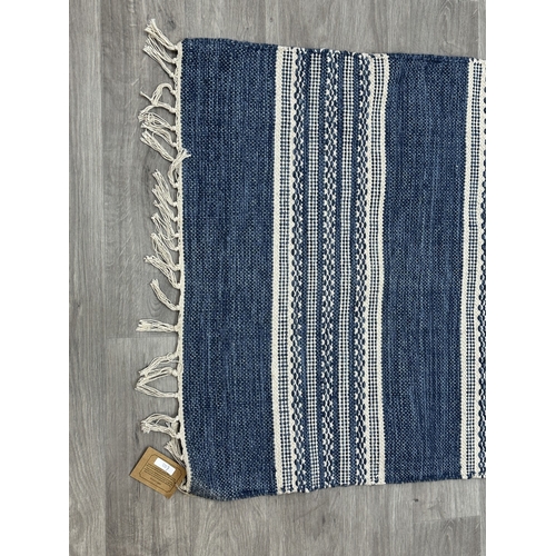 38 - Five Walton & Co 100% recycled PET yarn items, one throw - approx. 127cm x 152cm and four rugs, thre... 