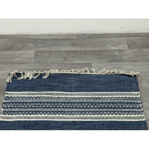 38 - Five Walton & Co 100% recycled PET yarn items, one throw - approx. 127cm x 152cm and four rugs, thre... 