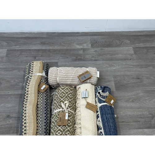 38 - Five Walton & Co 100% recycled PET yarn items, one throw - approx. 127cm x 152cm and four rugs, thre... 
