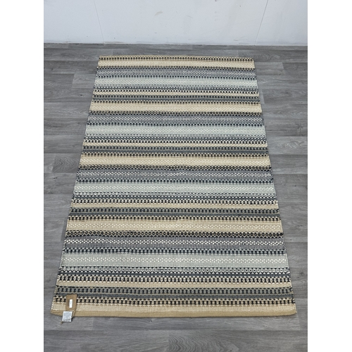 38 - Five Walton & Co 100% recycled PET yarn items, one throw - approx. 127cm x 152cm and four rugs, thre... 