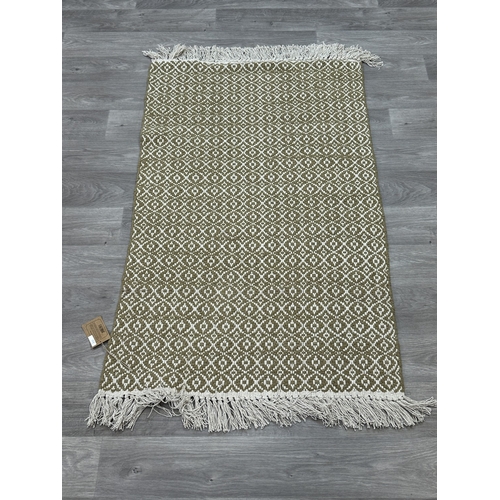 38 - Five Walton & Co 100% recycled PET yarn items, one throw - approx. 127cm x 152cm and four rugs, thre... 