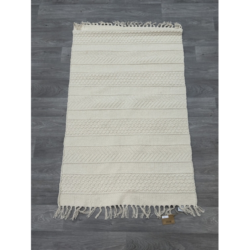 38 - Five Walton & Co 100% recycled PET yarn items, one throw - approx. 127cm x 152cm and four rugs, thre... 