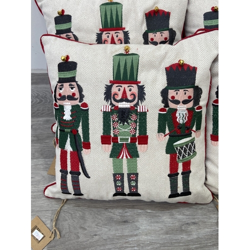 40 - Nine Walton & Co. Christmas themed fabric cushions, eight approx. 43cm x 43cm and one approx. 30cm x... 