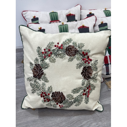 40 - Nine Walton & Co. Christmas themed fabric cushions, eight approx. 43cm x 43cm and one approx. 30cm x... 