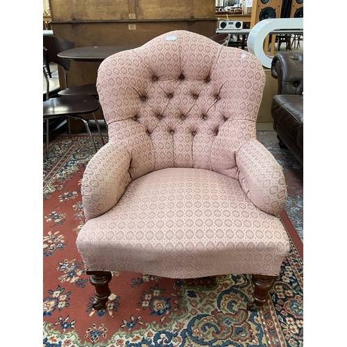 41 - A Victorian pink button back fabric upholstered armchair on turned mahogany supports and D&C Patent ... 