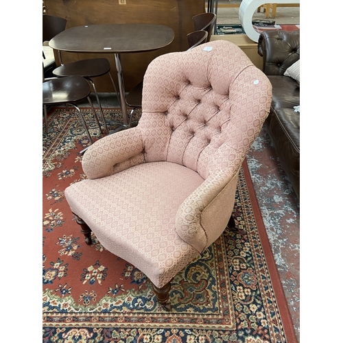 41 - A Victorian pink button back fabric upholstered armchair on turned mahogany supports and D&C Patent ... 