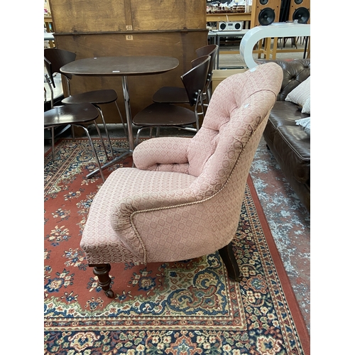 41 - A Victorian pink button back fabric upholstered armchair on turned mahogany supports and D&C Patent ... 