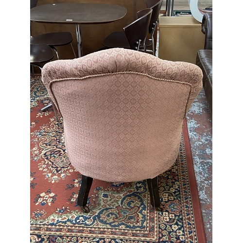 41 - A Victorian pink button back fabric upholstered armchair on turned mahogany supports and D&C Patent ... 