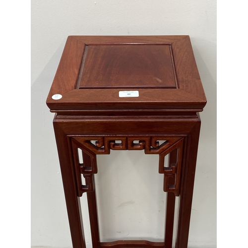 42 - A Chinese carved hardwood jardinière stand - approx. 91cm high x 30cm wide x 30cm deep