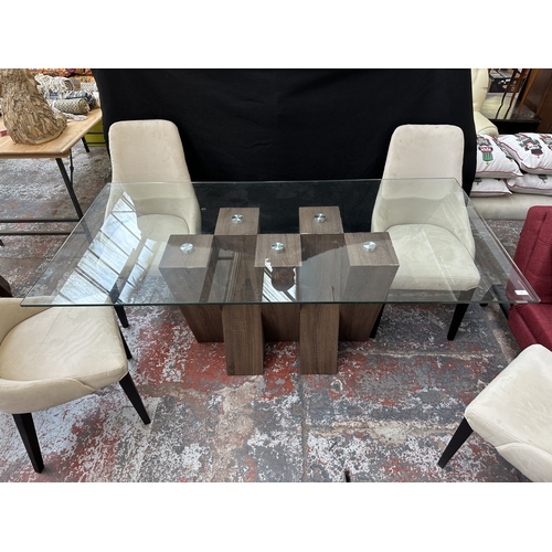 48 - A Harveys walnut effect and glass top Piston dining table and four beige buttoned fabric upholstered... 