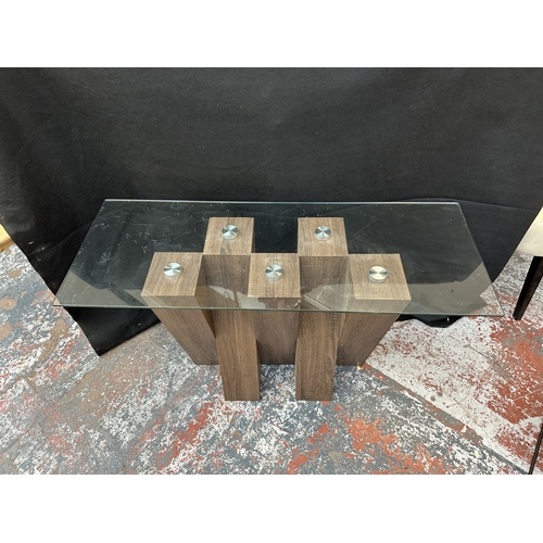 49 - Two Harveys walnut effect and glass top Piston occasional tables, one console - approx. 76cm high x ... 