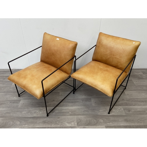 50 - A pair of Nkuku Durium style aged tan leather and iron lounger armchairs - approx. 80cm high x 59cm ... 