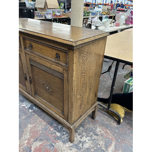 8A - An early 20th century carved oak sideboard - approx. 93cm high x 121cm wide x 44cm deep