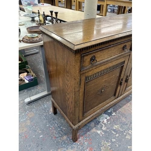 8A - An early 20th century carved oak sideboard - approx. 93cm high x 121cm wide x 44cm deep