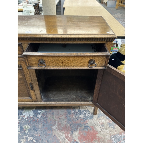 8A - An early 20th century carved oak sideboard - approx. 93cm high x 121cm wide x 44cm deep