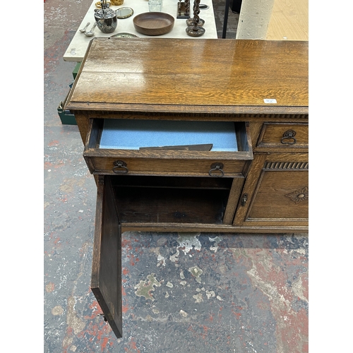 8A - An early 20th century carved oak sideboard - approx. 93cm high x 121cm wide x 44cm deep