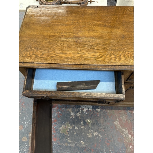 8A - An early 20th century carved oak sideboard - approx. 93cm high x 121cm wide x 44cm deep