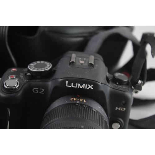 104 - Two digital cameras, one Panasonic Lumix DMC-G2 12.1mp mirrorless fitted with G Vario 1:3.5-5.6 14-4... 