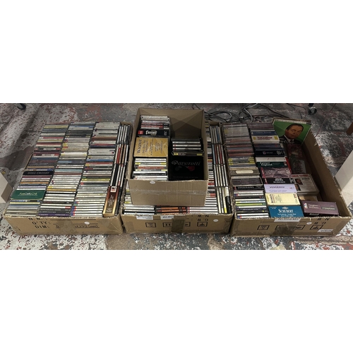 Four boxes containing mostly classical music CDs
