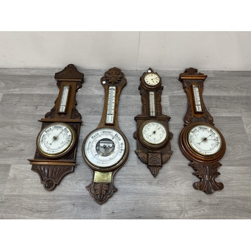 Four early 20th century carved oak cased aneroid barometers - largest ...