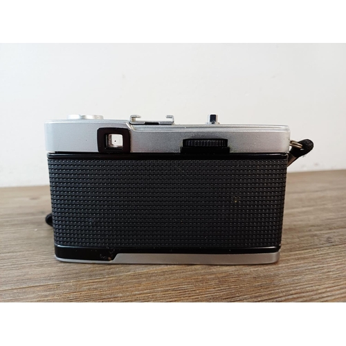 181 - A cased Olympus Trip 35 fully-automatic compact 35mm camera with wrist strap