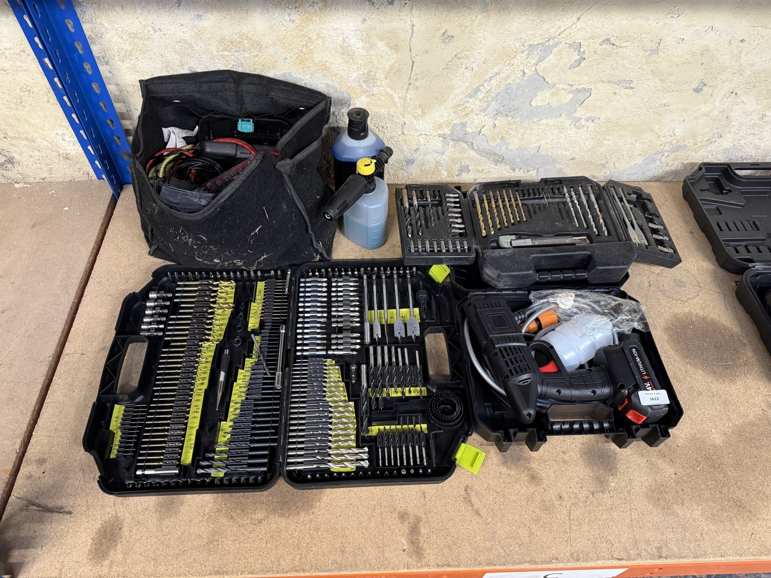 Four items, two drill bit sets, one cordless spray gun and one bag with ...