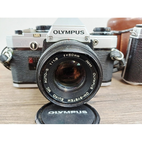 191 - Two 35mm cameras, one Olympus OM10 35mm SLR fitted with Zuiko MC Auto-S 1:1.8 50mm lens and one case... 
