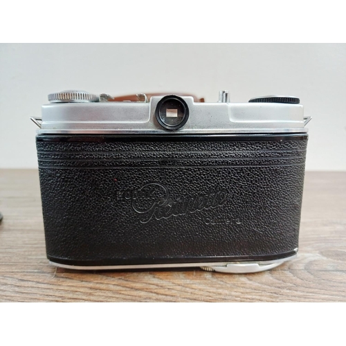 191 - Two 35mm cameras, one Olympus OM10 35mm SLR fitted with Zuiko MC Auto-S 1:1.8 50mm lens and one case... 