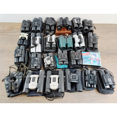 204 - Twenty-three cased pairs of pocket binoculars to include Nikon 7x20 CF III, two Nikon Sport Lite 10x... 