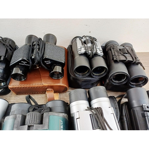 204 - Twenty-three cased pairs of pocket binoculars to include Nikon 7x20 CF III, two Nikon Sport Lite 10x... 