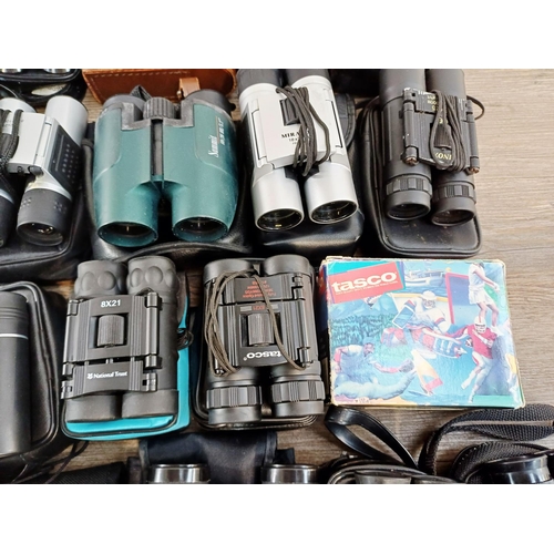 204 - Twenty-three cased pairs of pocket binoculars to include Nikon 7x20 CF III, two Nikon Sport Lite 10x... 