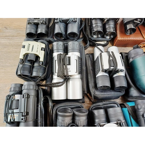 204 - Twenty-three cased pairs of pocket binoculars to include Nikon 7x20 CF III, two Nikon Sport Lite 10x... 