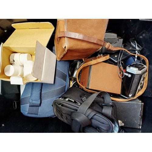 235 - A box containing cameras and photography accessories