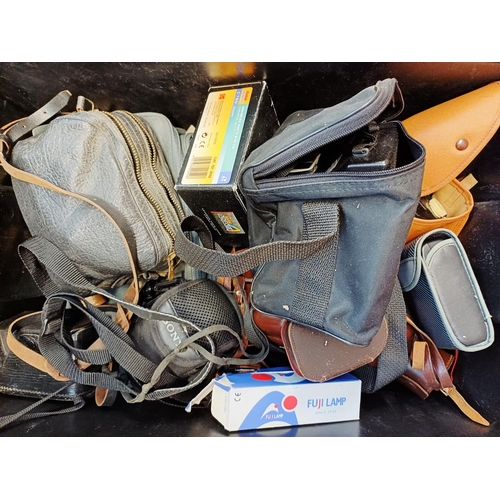 236 - A box containing cameras and photography accessories