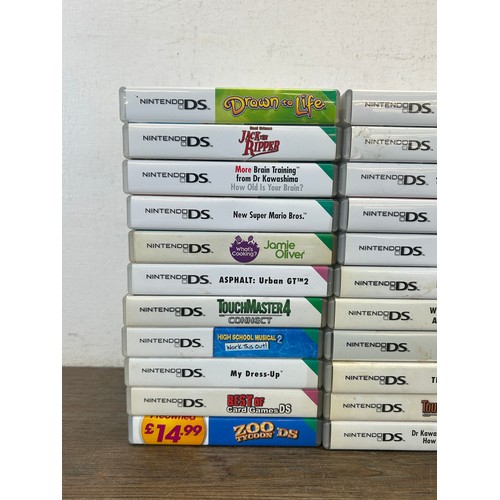 A large collection of Nintendo DS games together with a Nintendo DS ...