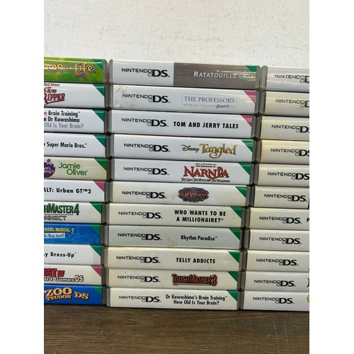 A large collection of Nintendo DS games together with a Nintendo DS ...