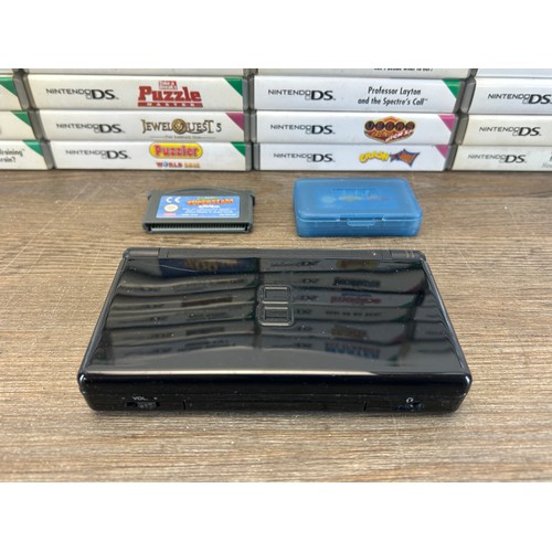 A large collection of Nintendo DS games together with a Nintendo DS ...