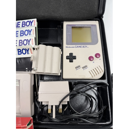 214 - A Nintendo Game Boy handheld game console with accessories and games to include Super Mario Land, Su... 
