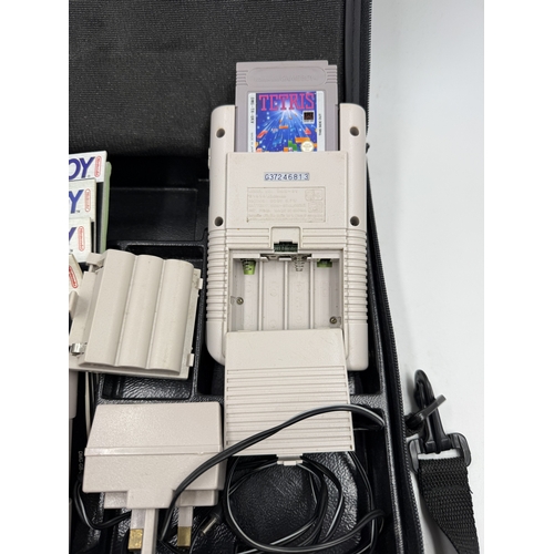 214 - A Nintendo Game Boy handheld game console with accessories and games to include Super Mario Land, Su... 