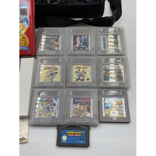 214 - A Nintendo Game Boy handheld game console with accessories and games to include Super Mario Land, Su... 
