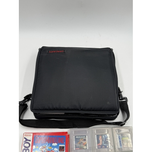 214 - A Nintendo Game Boy handheld game console with accessories and games to include Super Mario Land, Su... 