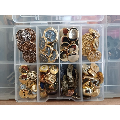 344 - Three boxes containing a very large quantity of buttons
