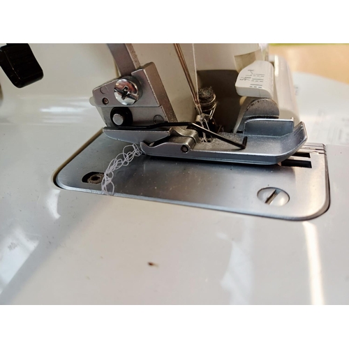 358 - A cased Janome My Lock 204D overlocker with foot pedal and instruction manual
