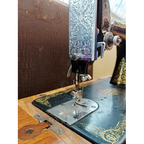 364 - A cased 1938 Singer 99K hand-crank sewing machine with accessories
