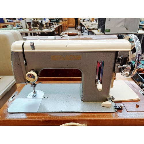 366 - A cased Frister & Rossmann electric sewing machine with foot pedal, attachments, accessories and ins... 