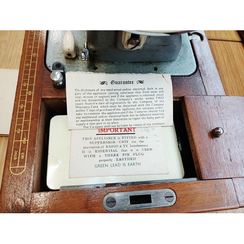 366 - A cased Frister & Rossmann electric sewing machine with foot pedal, attachments, accessories and ins... 